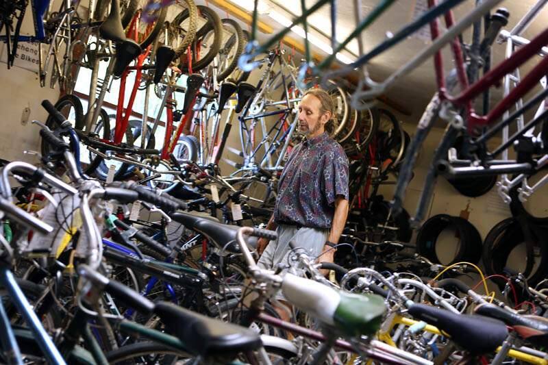 Michael Teller looks through his inventory of donated bicycles and bicycle parts at Community Bikes off of Sebastopol Road in Santa Rosa on Thursday, July 25, 2013. (Conner Jay / The Press Democrat)