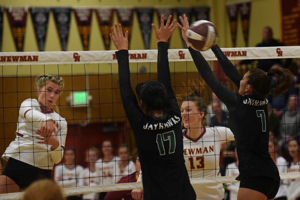 Cardinal Newman Outside Hitter Cami Loxley, far left, slams the ball over the net next to teammate Julia Donlon and between Head-Royce players Agnes Gatdula, #17 and Sidney Shah, #7 during the NCS volleyball semifinal held Wednesday at Cardinal Newman High School in Santa Rosa, California. November 6, 2019.(Photo: Erik Castro/for The Press Democrat)
