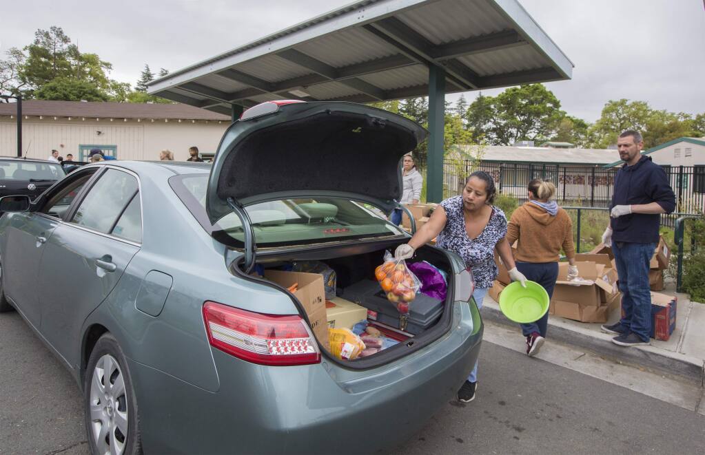 Denia Olea was one of many volunteers who distributed food from the Redwood Empire Food bank at the Flowery Elementary School in Boys Hot Springs on Monday, March 30. (Photo by Robbi Pengelly/Index-Tribune)