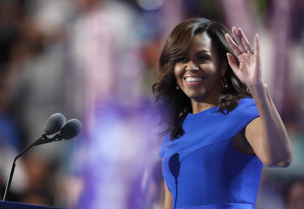 Michelle Obama waves to delegates on the first night of the Democratic National Convention in Philadelphia. (PAUL SANCYA / Associated Press)