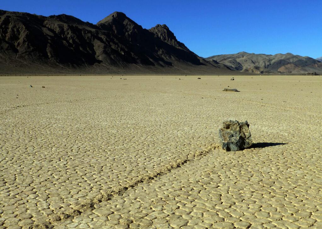 This undated photo provided by the National Park Service shows rocks that have moved across a dry lake bed in Death Valley National Park in California's Mojave Desert. (AP Photo/National Park Service)