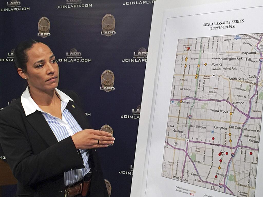 Los Angeles Police Det. Dara E. Brown shows a map of locations where an alleged serial rapist is believed to have attacked his victims, at a news conference at LAPD headquarters in downtown Los Angeles Wednesday, Jan. 17, 2018. Officials say police and Los Angeles County Sheriff's deputies arrested a man they describe as a serial rapist when they saw a victim who had fought him off fall from his car on Friday, Jan. 12. He was identified as 35-year-old Ferdinand Ervin Flowers of Long Beach. (AP Photo/Robert Jablon)