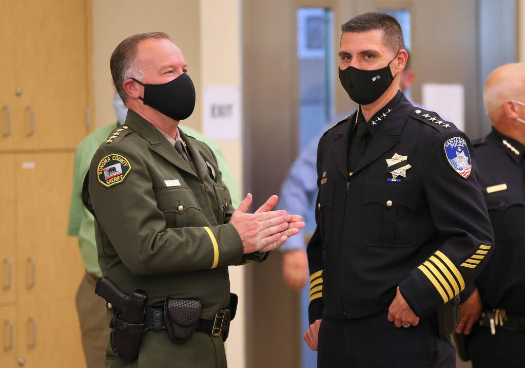 (FILE PHOTO) Sonoma County Sheriff Mark Essick, left, and Santa Rosa Police Chief Ray Navarro talk before the start of a press conference addressing local police reform, in Santa Rosa on Wednesday, June 10, 2020. (Christopher Chung/ The Press Democrat)