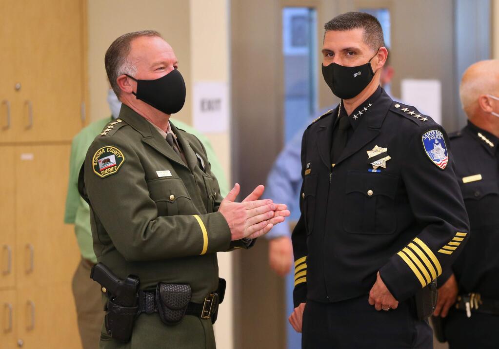 Sonoma County Sheriff Mark Essick, left, and Santa Rosa Police Chief Ray Navarro talk before the start of a press conference addressing local police reform, in Santa Rosa on Wednesday, June 10, 2020. (Christopher Chung/ The Press Democrat)