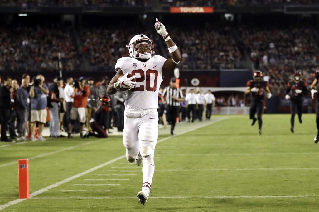 In this Sept. 16, 2017, file photo, Stanford running back Bryce Love scores a touchdown during the second half against San Diego State in San Diego. He leads the nation in rushing at 196.75 yards per game and is averaging 10.78 yards per carry. In each game this season, Love has broken off a run of 50 yards or more. (AP Photo/Gregory Bull, File)
