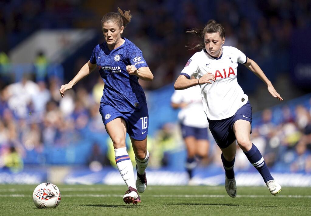 Chelsea's Maren Mjelde, left, and Tottenham Hotspur's Lucy Quinn battle for the ball during the Women's Super League soccer match at Stamford Bridge, London, Sunday Sept. 8, 2019. (John Walton/PA via AP)