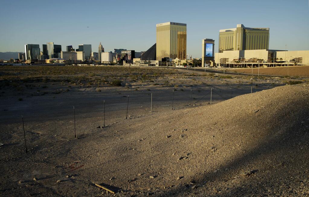 In this May 1, 2017, photo, land purchased by the Oakland Raiders near the Las Vegas Strip where their future home is to be located in Las Vegas, is lit by late-afternoon sunlight. Public records show the team paid $77.5 million for the four parcels in an area close to the Mandalay Bay hotel-casino. (AP Photo/John Locher)
