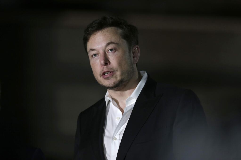 FILE- In this June 14, 2018, file photo Tesla CEO and founder of the Boring Company Elon Musk speaks at a news conference in Chicago. Musk says he is considering taking the electric car maker private. Tesla's stock spiked Tuesday, Aug. 7, after Musk made the abrupt announcement in a terse tweet. (AP Photo/Kiichiro Sato, File)
