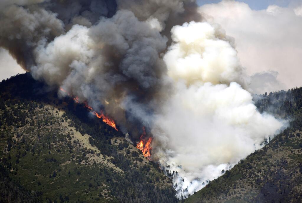 A wildfire burns up a steep canyon Sunday, July 8, 2018, near La Veta, Colo. (Helen H. Richardson /The Denver Post via AP)