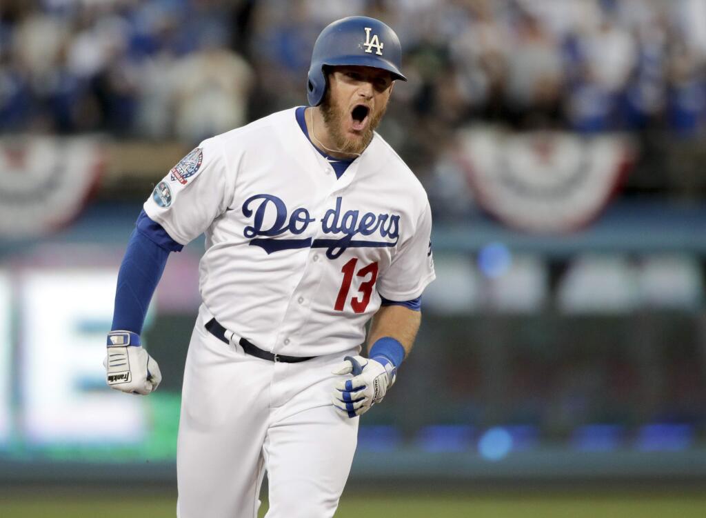 Los Angeles Dodgers' Max Muncy celebrates after hitting a three-run home run during the second inning of Game 1 of a baseball National League Division Series against the Atlanta Braves on Thursday, Oct. 4, 2018, in Los Angeles.(AP Photo/Jae C. Hong)