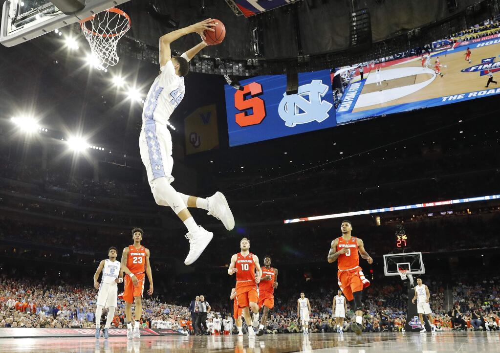 North Carolina forward Justin Jackson (44) dunks the ball on Syracuse during the second half of the NCAA Final Four tournament college basketball semifinal game Saturday, April 2, 2016, in Houston. (AP Photo/David J. Phillip)
