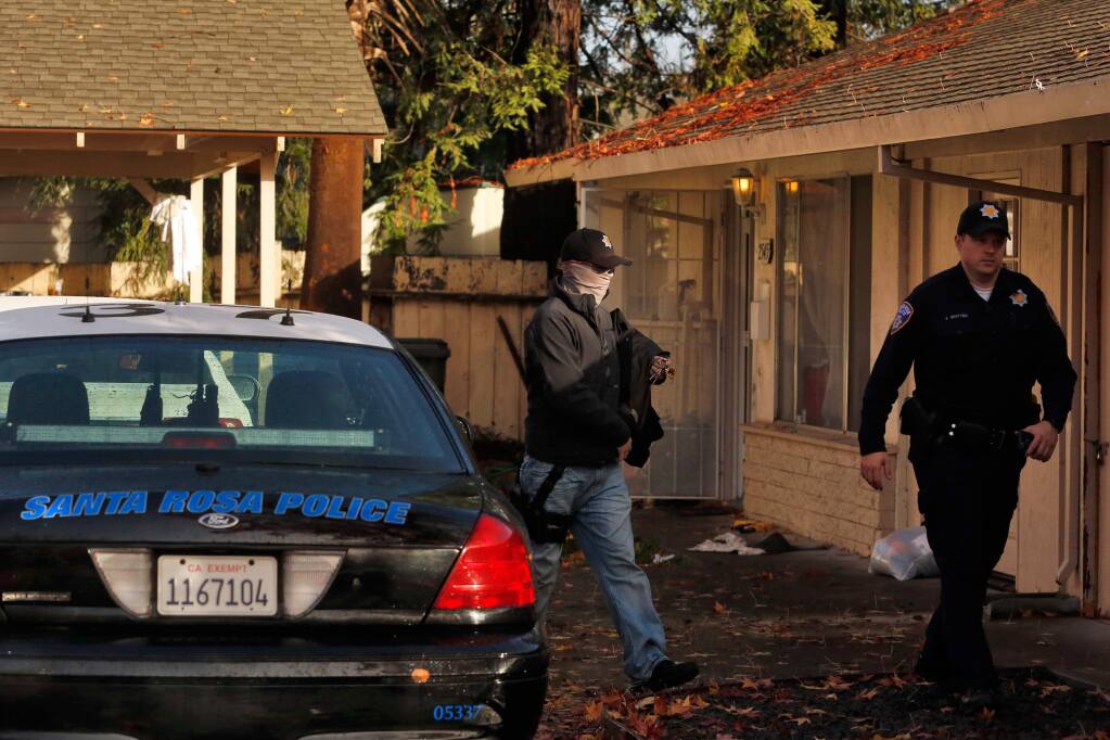 Santa Rosa Police and federal agents investigate the scene of an early morning drug bust near West Steele Lane, in Santa Rosa, California on Thursday, December 10, 2015. (Alvin Jornada / The Press Democrat)