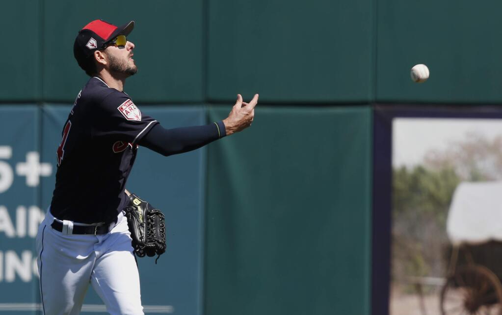 Cleveland Indians right fielder Matt Joyce tosses a ball to a fan in the third inning of a spring training game against the Colorado Rockies, Thursday, March 14, 2019, in Goodyear, Ariz. (AP Photo/Sue Ogrocki)
