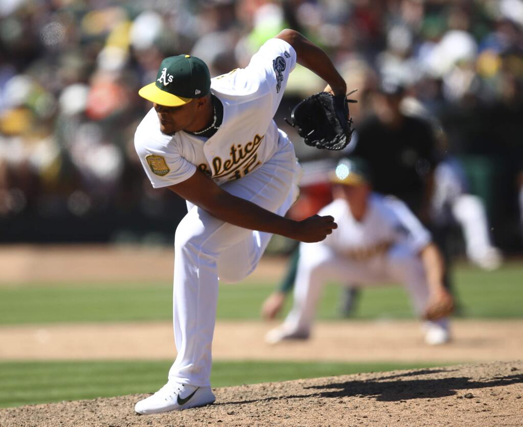 Oakland Athletics pitcher Jeurys Familia works against the San Francisco Giants in the ninth inning Sunday, July 22, 2018, in Oakland. (AP Photo/Ben Margot)