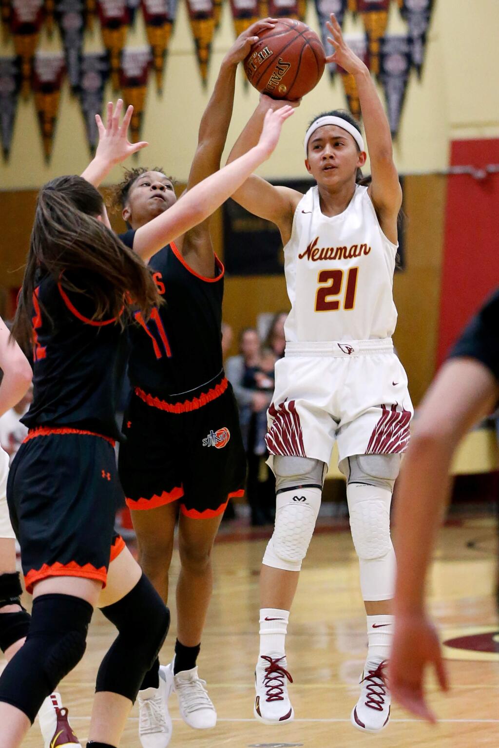 Cardinal Newman's Avery Cargill (21), right, tries to shoot from outside but gets blocked by St. Joseph Notre Dame's Zhane Duckett (11), second from left, during the first half of an NCS Division 3 girls varsity basketball playoff game between St. Joseph Notre Dame and Cardinal Newman high schools, in Santa Rosa, California, on Wednesday, February 20, 2019. (Alvin Jornada / The Press Democrat)