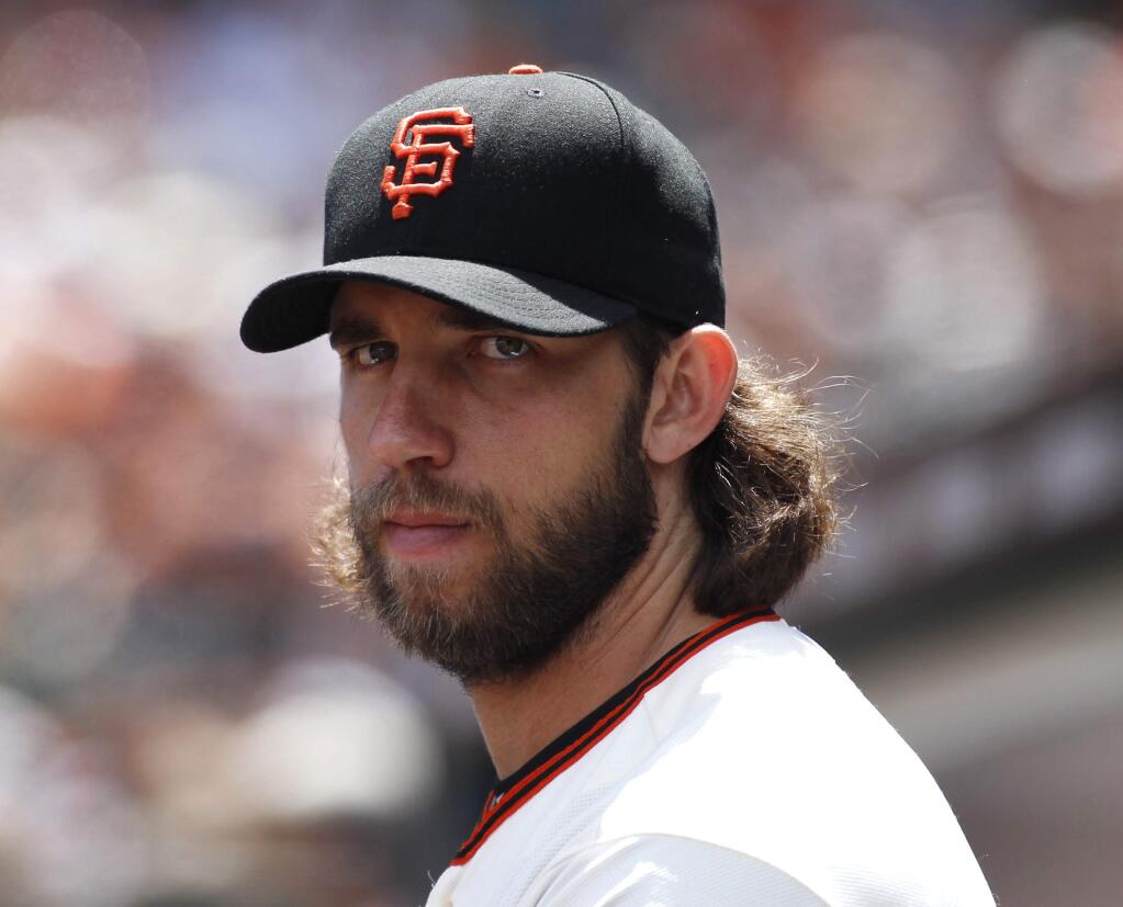 San Francisco Giants' Madison Bumgarner looks on during the fourth inning of a baseball game against the Colorado Rockies, Saturday, June 27, 2015, in San Francisco. (AP Photo/George Nikitin)