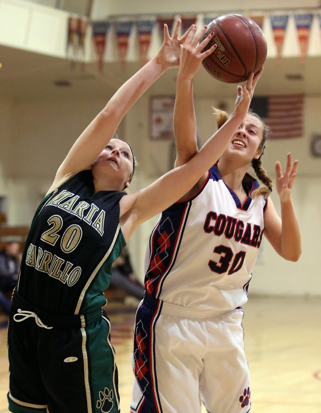 Maria Carrillo's Claire Howard, left, and Rancho Cotate's Camille Spackman, right, go up for the rebound during the game held at Rancho Cotate High School, Tuesday, January 6, 2015. (Crista Jeremiason / The Press Democrat)