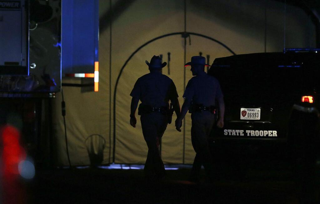 Law enforcement officials work at scene of a shooting at the First Baptist Church of Sutherland Springs, Texas, Sunday Nov 5, 2017. (Edward A. Ornelas/The San Antonio Express-News via AP)
