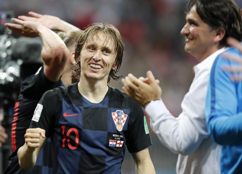 Croatia's Luka Modric celebrates with head coach Zlatko Dalic after advancing to the final during the semifinal match between Croatia and England at the 2018 World Cup in the Luzhniki Stadium in Moscow, Russia, Wednesday, July 11, 2018. (AP Photo/Frank Augstein)