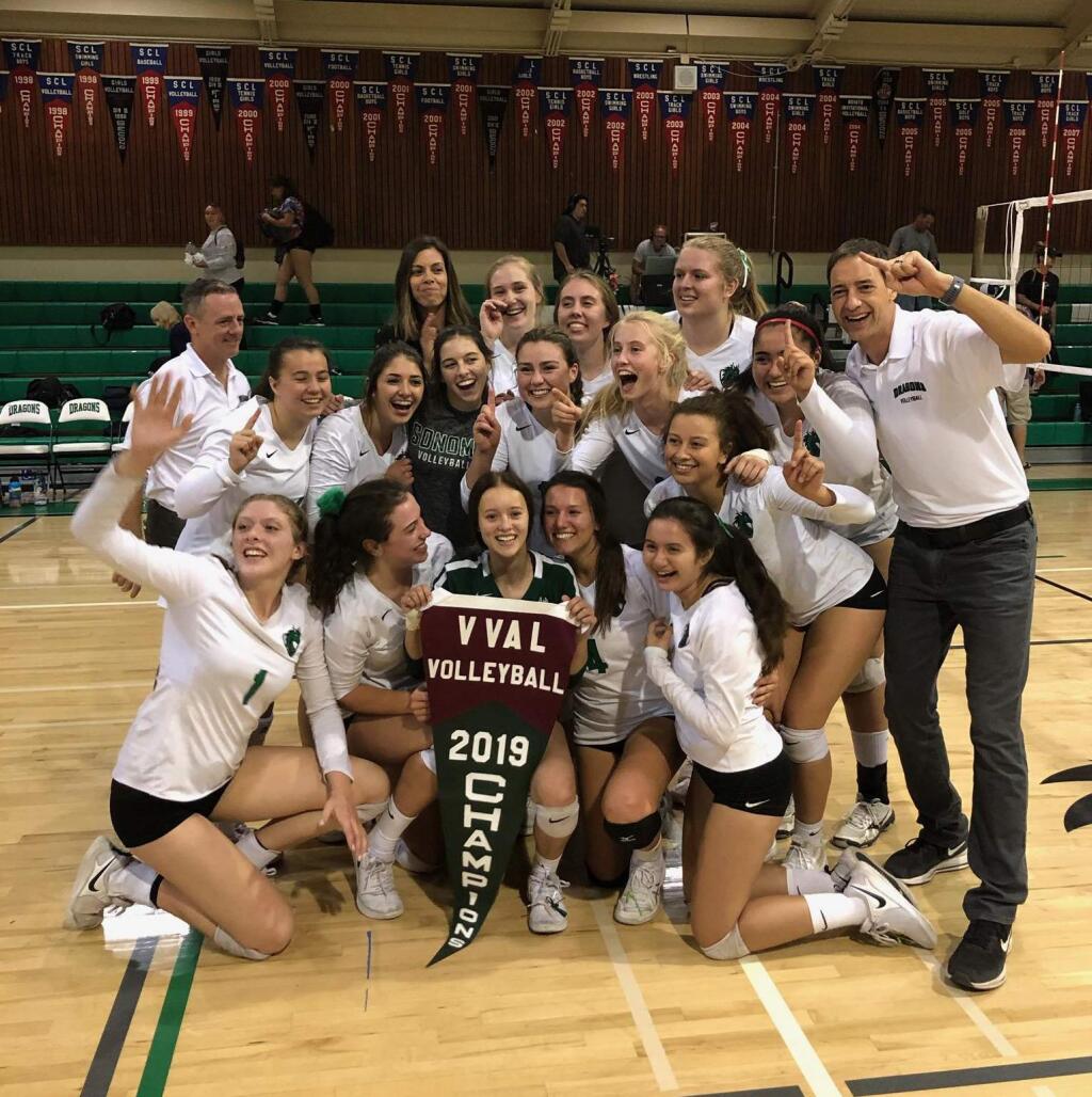 Sonoma Valley's varsity volleyball team celebrate their first VVAL pennant, following a 3-set win over Petaluma at Pfeiffer Gym, Thursday, Oct. 24. (Mike Boles)