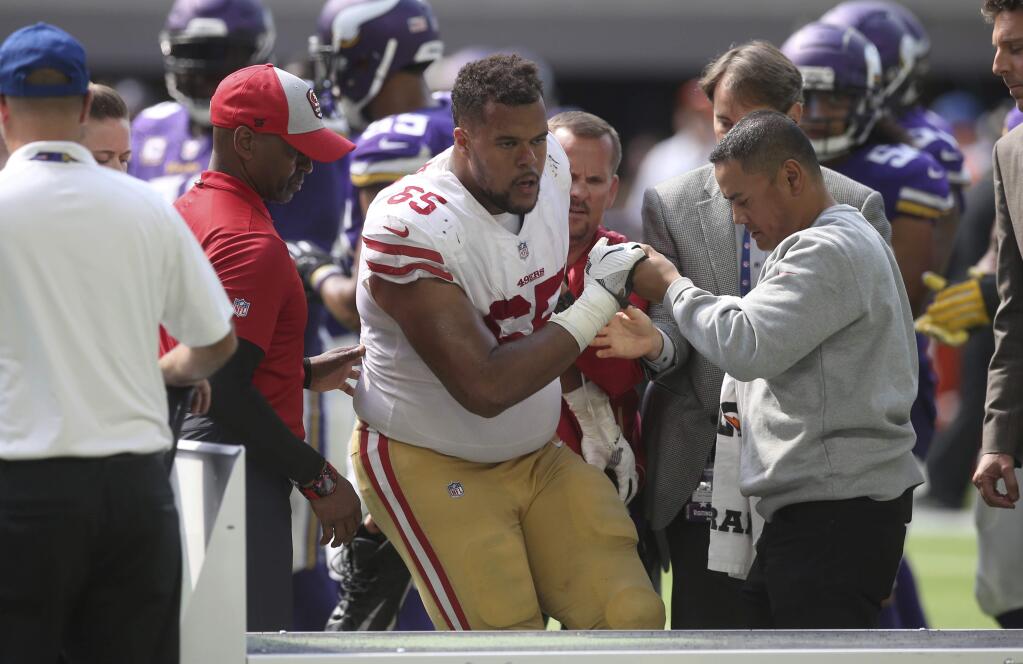 San Francisco 49ers offensive guard Joshua Garnett is helped off the field after getting injured during the second half against the Minnesota Vikings, Sunday, Sept. 9, 2018, in Minneapolis. (AP Photo/Jim Mone)