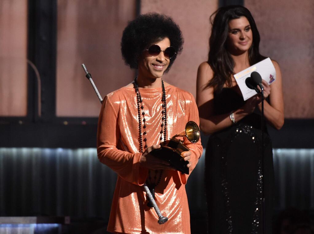 FILE - In this Feb. 8, 2015, file photo, Prince presents the award for album of the year at the 57th annual Grammy Awards in Los Angeles. Beyond dance parties and hit songs, Princes legacy included black activism. He said black lives matter before presenting a 2015 Grammy. (Photo by John Shearer/Invision/AP, File)