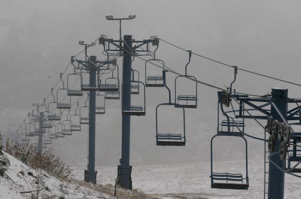 A chair lift sits idle at the Donner Ski Ranch near Soda Springs, Calif., Friday, Nov. 3, 2017. A light snow fell in the upper elevations of the Sierra Nevada overnight, but not enough snow was received for ski resorts in the Donner Summit area to open. This weekend, up to 2 feet of snow are forecast to fall in elevations above 8,000 feet and at least a foot of snow is expected in Donner and Tioga passes and other areas above 6,000 feet and up, forecasters said. (AP Photo/Rich Pedroncelli)