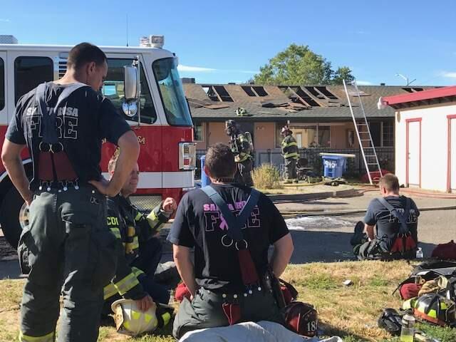 Firefighters catch their breath after controlling an apartment building fire Thursday on Aston Avenue. (Photo courtesy Santa Rosa Fire Department)