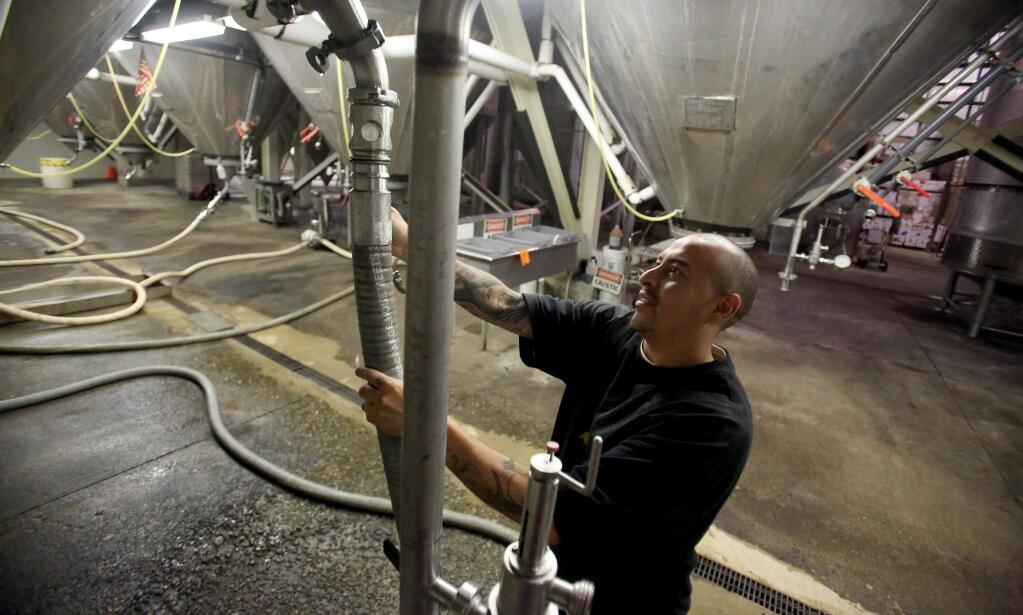 Orlando Nieves, a filler operator, prepares to move finished product to the bottling facility at Mendocino Brewing Co. in Ukiah in 2013. (PD FILE)