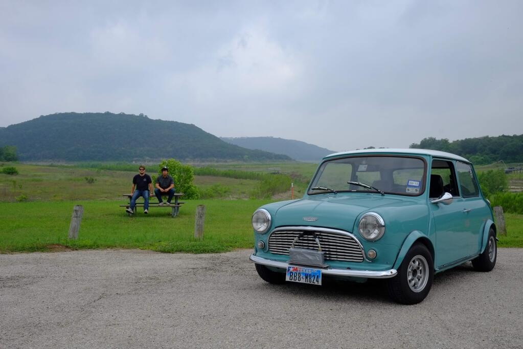 Nick Bokaie and Roberto Rosila pcitured sitting next to the Mini Cooper they plan to drive in the 10,000 mile Mongol Rally. (Photo courtesy of Nick Boakie)