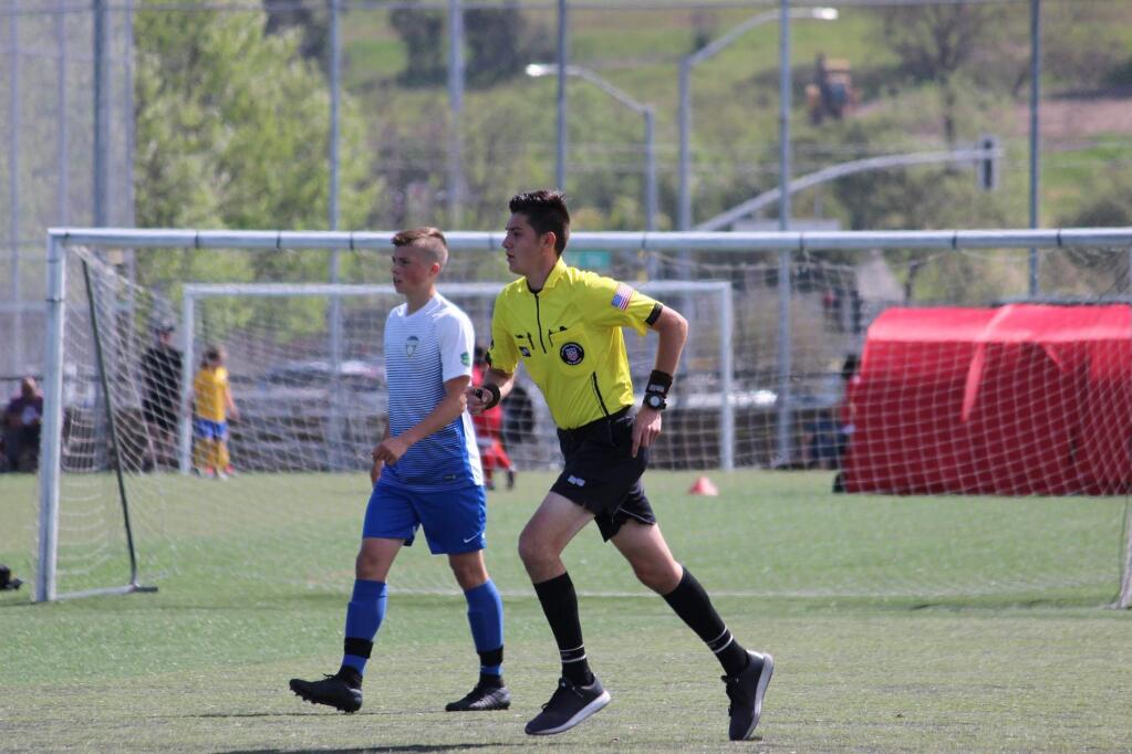 Adolfo Membrila dons the yellow referee's jersey in a recent club soccer game. Membrila, a 2019 El Molino High graduate, has been officiating soccer since he was 12. (Zach Strehlow)
