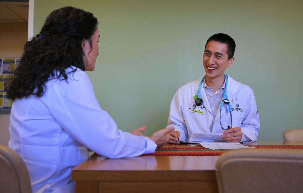 Third-year medical student Jonathan Tran, right, meets with Dr. Patricia Hiserote, Program Director of the Kaiser Permanente Santa Rosa Family Medicine Residency Program, at the medical offices in Santa Rosa on Monday, May 8, 2017. (Christopher Chung/ The Press Democrat)