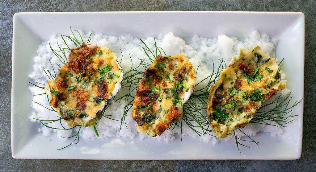 Baked Oysters Bucher with kale, artichoke, leeks, cream, bacon and truffle butter from Lovina in Calistoga. (photo by John Burgess/The Press Democrat)