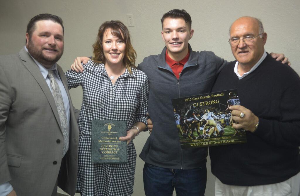 SUMNER FOWLER/FOR THE ARGUS-COURIERDylan Roberts who came back from severe injuries suffered in a pre-season motorcycle accient received Casa Grande's first CJ Strong award in honor of CJ Banasek. On hand for the presentation were, left to right, varsity coach Trent Herzog. CJ's mother Heather Banaszek, Roberts and CJ's grandfather Cas Banaszek.