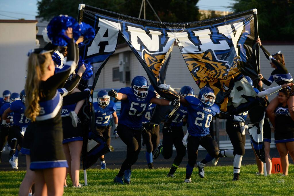 Running back Ja'Narrick James (20) and lineman Henry Campbell (57) lead the Analy Tigers onto the field before a varsity football game between Casa Grande and Analy high schools in Sebastopol, California, on August 29, 2014. (Alvin Jornada / For The Press Democrat)