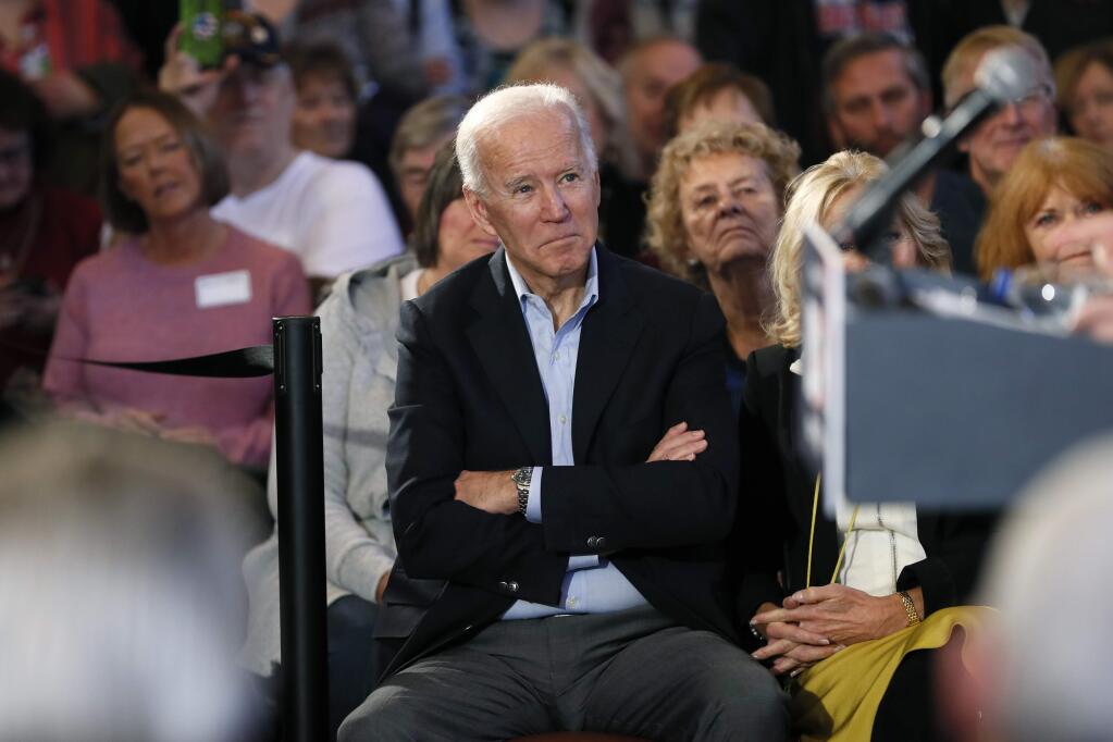Democratic presidential candidate former Vice President Joe Biden waits to speak to local residents during a bus tour stop, Tuesday, Dec. 3, 2019, in Mason City, Iowa. (AP Photo/Charlie Neibergall)