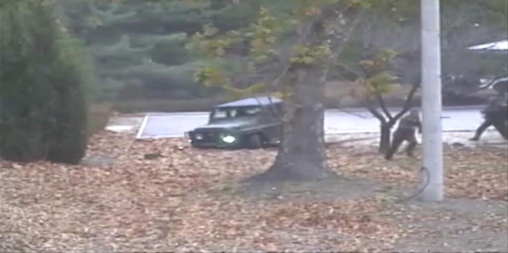 This image made from Nov. 13, 2017, surveillance video released by the United Nations command shows a North Korean soldier, second right, running from a jeep and later shot by North Korean soldiers at right. A North Korean soldier made a desperate dash to freedom in a jeep and then on foot, being shot at least five times as he limped across the border and was rescued by South Korean soldiers, according to dramatic video released by the U.S.-led U.N. command Wednesday, Nov. 22, 2017. (United Nations Command via AP)