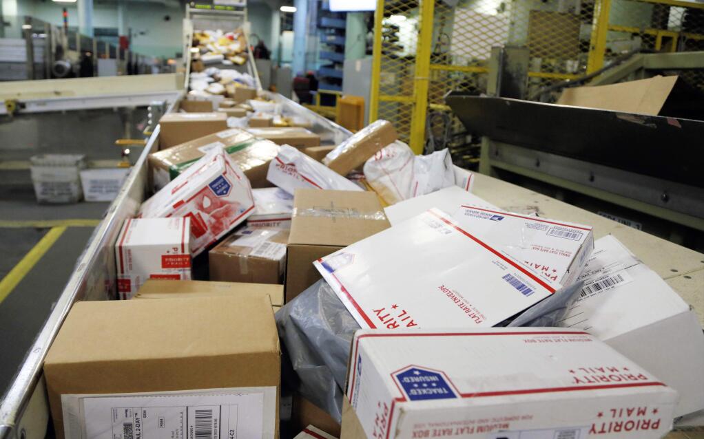 FILE- In this Dec. 14, 2017, file photo, packages travel on a conveyor belt for sorting at the main post office in Omaha, Neb. States will be able to force shoppers to pay sales tax when they make online purchases under a Supreme Court decision Thursday, June 21, 2018, that will leave shoppers with lighter wallets but is a big win for states. (AP Photo/Nati Harnik, File)