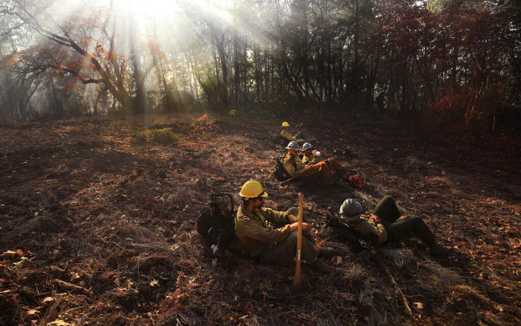 Eldorado Hotshots out of Camino take a break from cutting fire breaks on Kincade fire, Tuesday, Oct. 29, 2019, near the Sonoma/ Lake County line. (KENT PORTER/ PD)