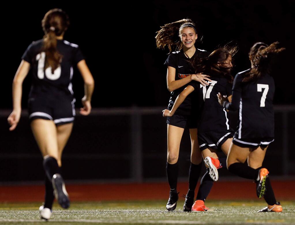 The Santa Rosa Panthers celebrate a goal scored by Avery West, center, during the second half between Rancho Cotate and Santa Rosa high schools in Santa Rosa on Tuesday, Jan. 22, 2019. (Alvin Jornada / The Press Democrat)