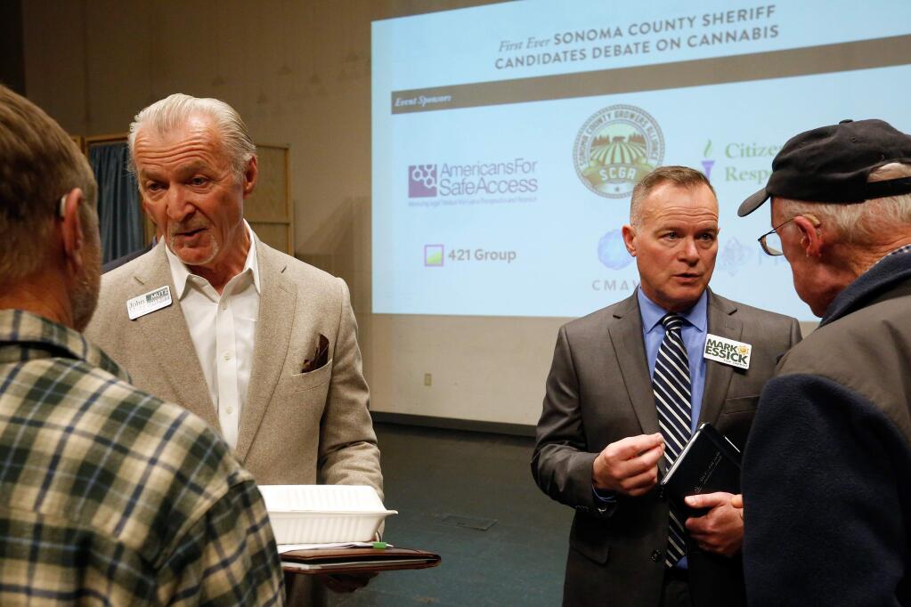 Sonoma County sheriff candidates John Mutz, left, and Mark Essick talk with audience members after a recent campaign forum. (ALVIN JORNADA / The Press Democrat)