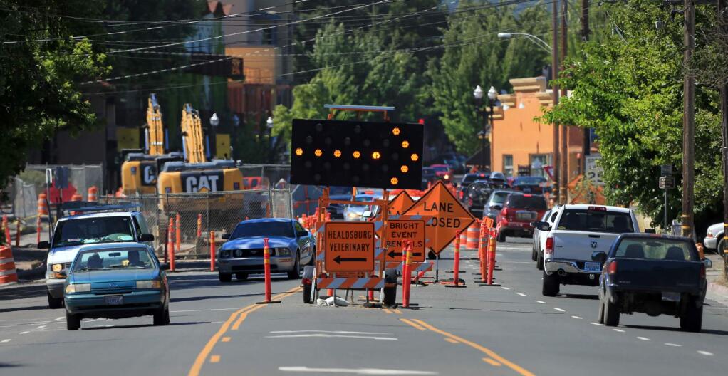 From the southern entrance to Healdsburg Avenue, a phalanx of road signs and markers split the traffic in to the under construction roundabout , Monday June 26, 2017. (Kent Porter / Press Democrat) 2017