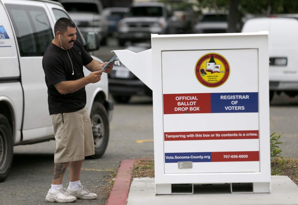Alex Ruiz puts his ballot in the drop box in the parking lot of the Santa Rosa Veterans Memorial Building in Santa Rosa, on Tuesday, June 7, 2016. (BETH SCHLANKER/ The Press Democrat)
