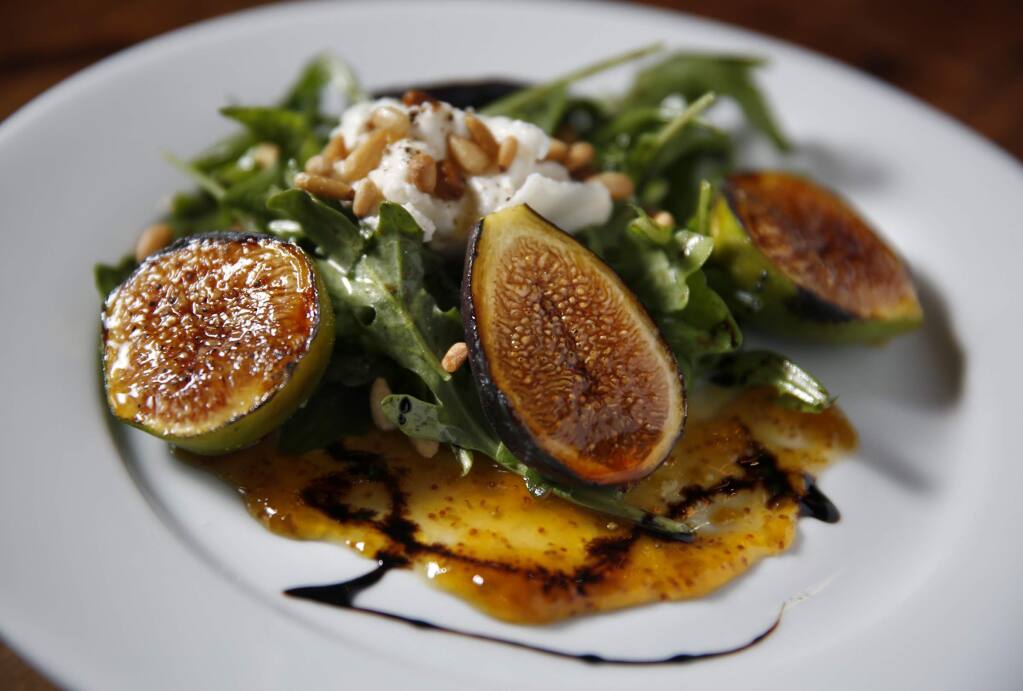Roasted figs with burrata cheese, arugula and pine nuts at K&L Bistro in Sebastopol, on Tuesday, June 24, 2014. (Beth Schlanker / The Press Democrat)