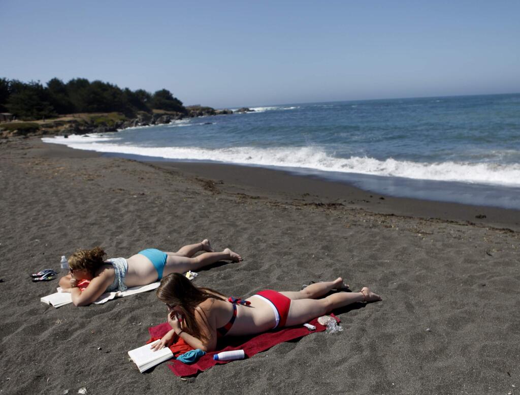 Trista St. Martin, left, and Casey Shand, both Canadian, try to get a little sun despite the chilly breeze at MacKerricher State Park on Thursday, Sept. 1, 2011, three miles north of Fort Bragg near the town of Cleone, California. (Beth Schlanker/The Press Democrat)