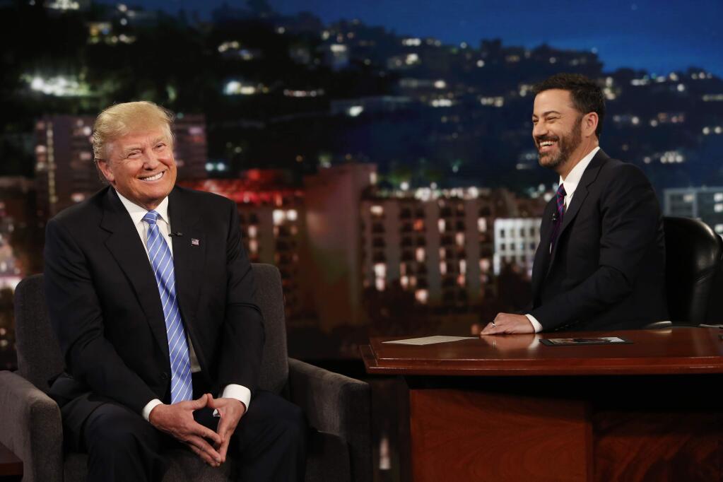 In this photo provided by ABC, Republican presidential candidate, Donald Trump, left, talks with host Jimmy Kimmel during a taping of the ABC television show, 'Jimmy Kimmel Live!, on Wednesday, May 25, 2016, in Los Angeles. Trump made an appearance as a guest, along with musical guest Greg Porter on the late night show, which airs every weeknight at 11:35 p.m. EST. (Randy Holmes/ABC via AP)