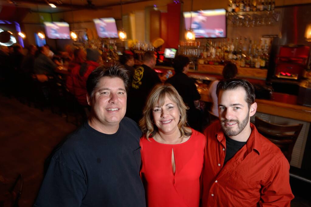 Alvin Jornada / The Press Democrat Bar owners Dan and Traci Thompson with their son Chase Myers, right, at Tradewinds Bar in Cotati.