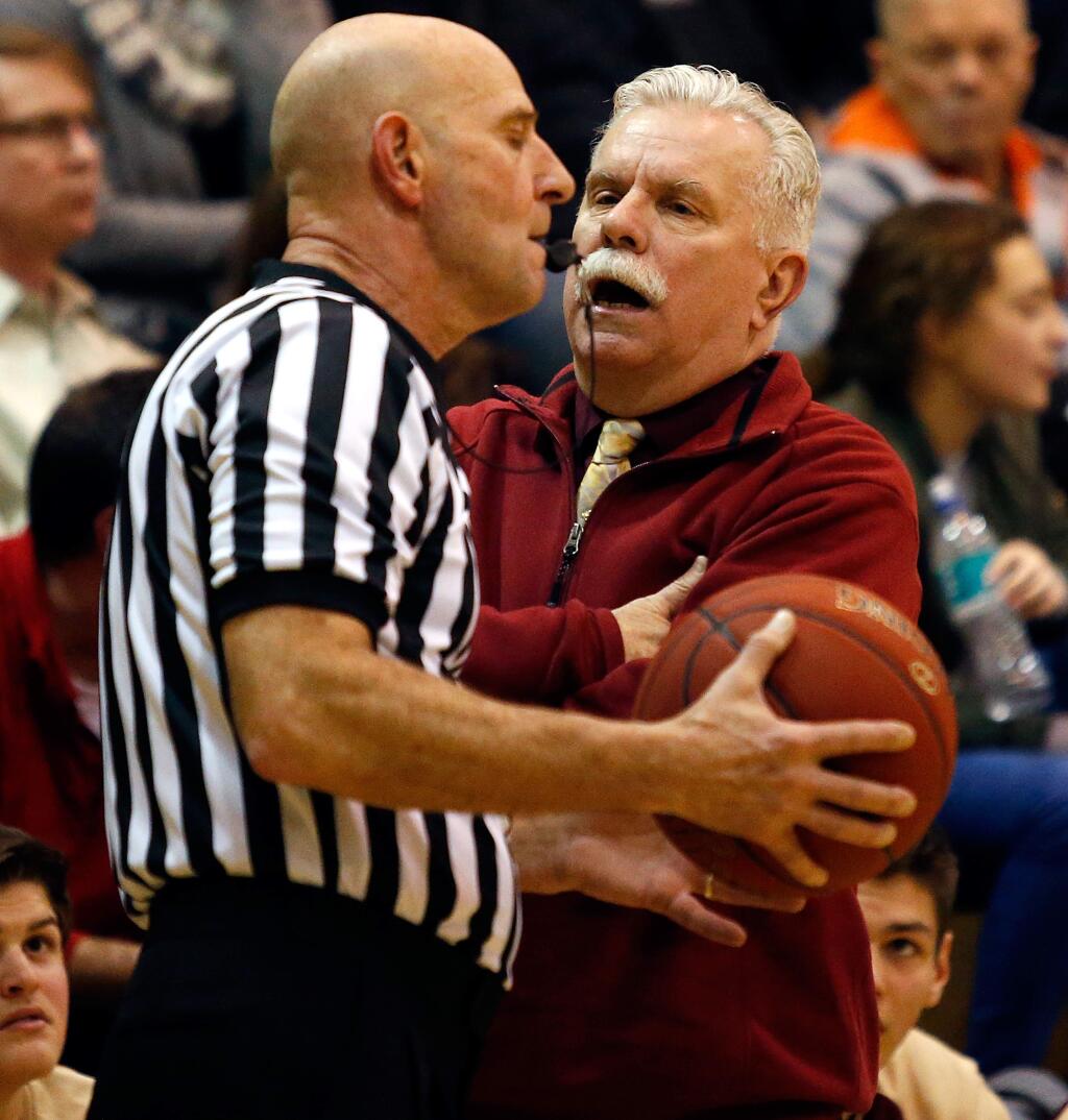Cardinal Newman head coach Tom Bonfigli, right, talks with a referee during the second half of a boys varsity basketball game between Cardinal Newman and Windsor high schools in Windsor, California on Thursday, January 19, 2017. (Alvin Jornada / The Press Democrat)