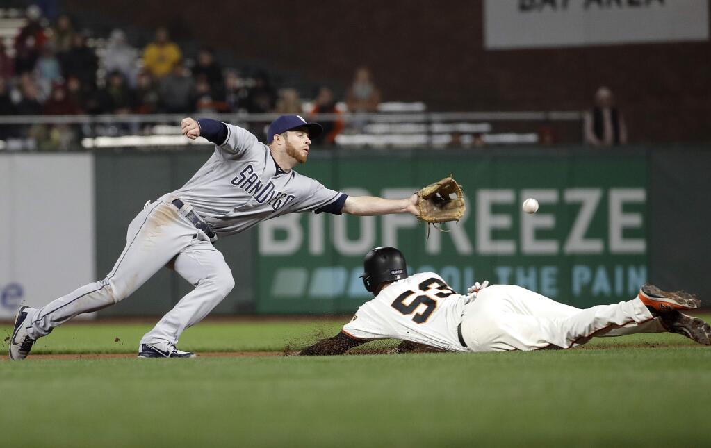San Francisco Giants' Austin Slater (53) steals second base under San Diego Padres' Cory Spangenberg during the fifth inning of a baseball game in San Francisco, Wednesday, Sept. 26, 2018. (AP Photo/Jeff Chiu)