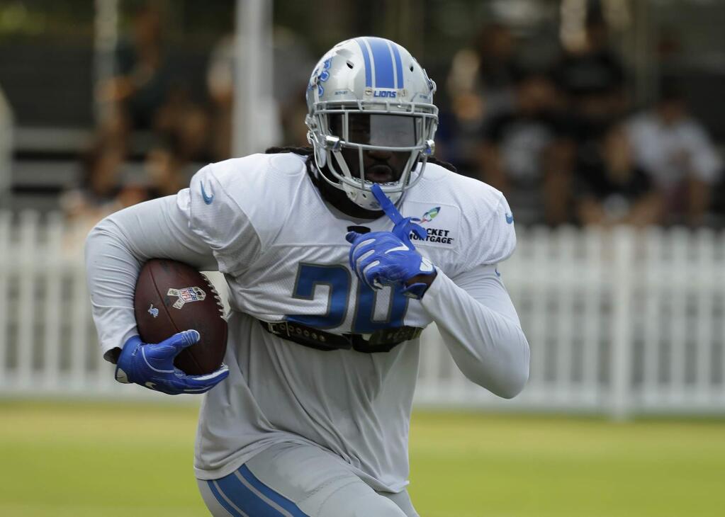 Detroit Lions running back LeGarrette Blount runs with the ball during NFL football practice Tuesday, Aug. 7, 2018, in Napa, Calif. The Oakland Raiders and the Lions held a joint practice before their upcoming preseason game on Friday. (AP Photo/Eric Risberg)